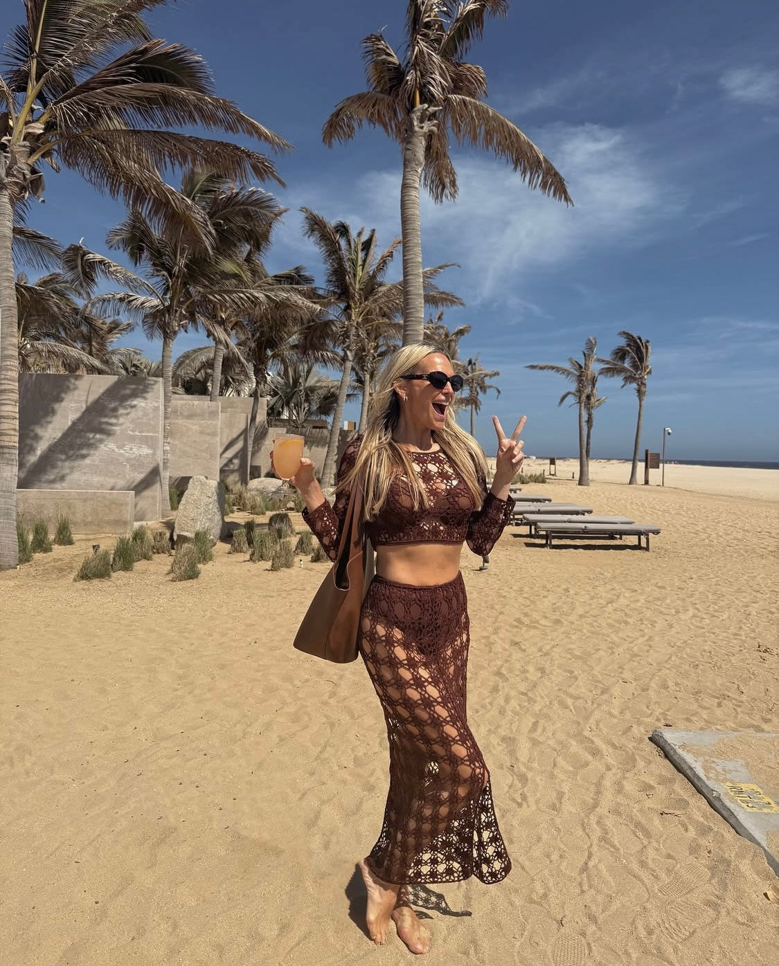 Molly Sims is wearing Anna Kosturova handmade crochet Bella top and skirt in Cabo