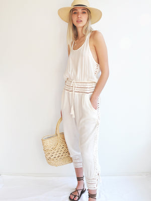 Anna Kosturova Relaxed fit romper with handmade crochet inserts at the waist and as the leg cuffs with incased button closure, embellished with tassels. Unique and comfortable festival look. 