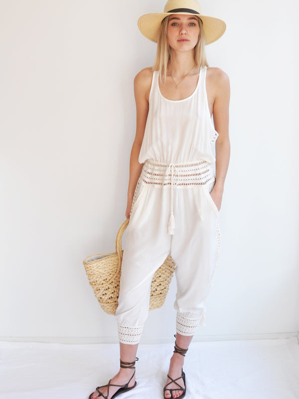 Anna Kosturova Relaxed fit romper with handmade crochet inserts at the waist and as the leg cuffs with incased button closure, embellished with tassels. Unique and comfortable festival look.