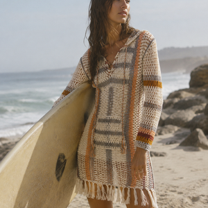 Anna Kosturova-Our handmade crochet Sahara Hoodie Dress is a super chill and rustic piece. With a splash of warm colours and fringe trimmed hem this dress is perfect for a casual summer day. Complete with a front pocket and multi-coloured, braided, drawstring lace-up neckline. Removable liner.